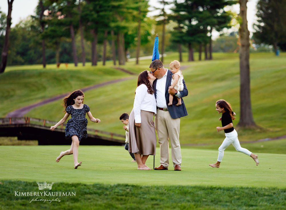 Family with four children laughing during golden hour in Bucks County, PA