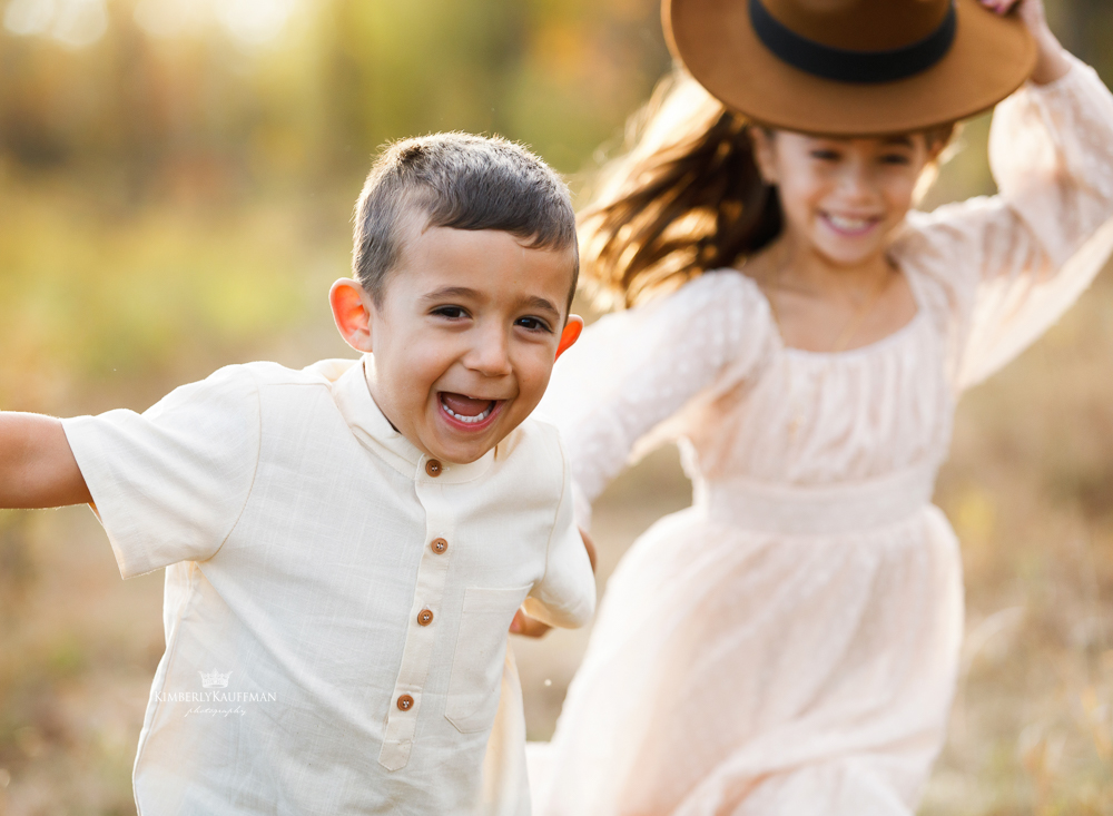 Close-up of children smiling at golden hour.