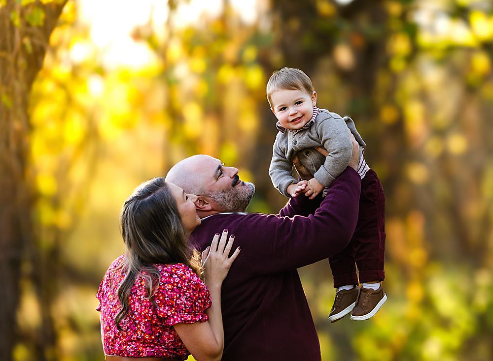 Child on dad’s shoulders during golden hour family portraits in Bucks County, PA
